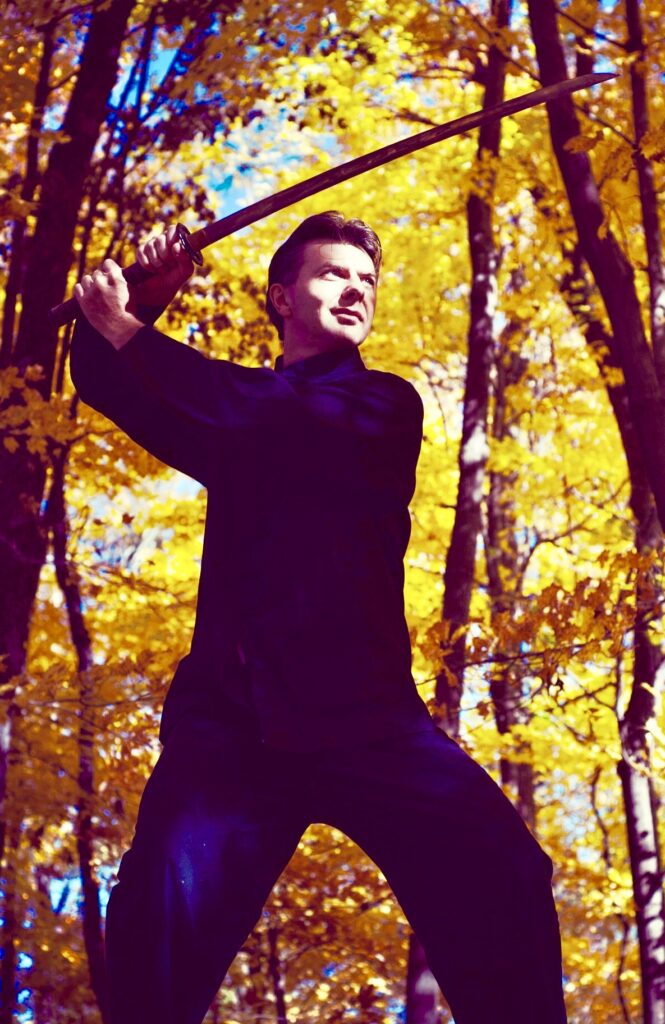 Dmitrij practicing with a sword on an autumn day